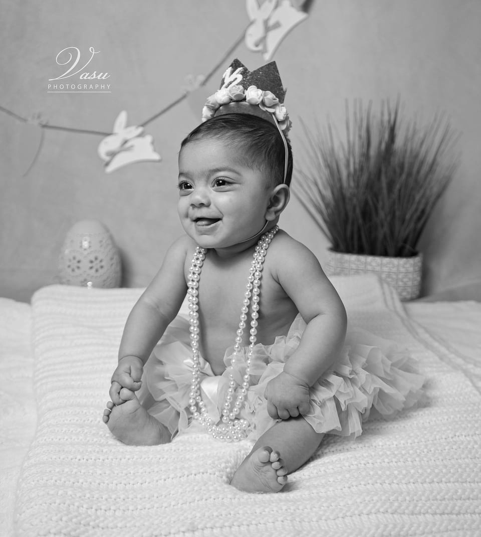 A smiling child seated during a studio portrait session