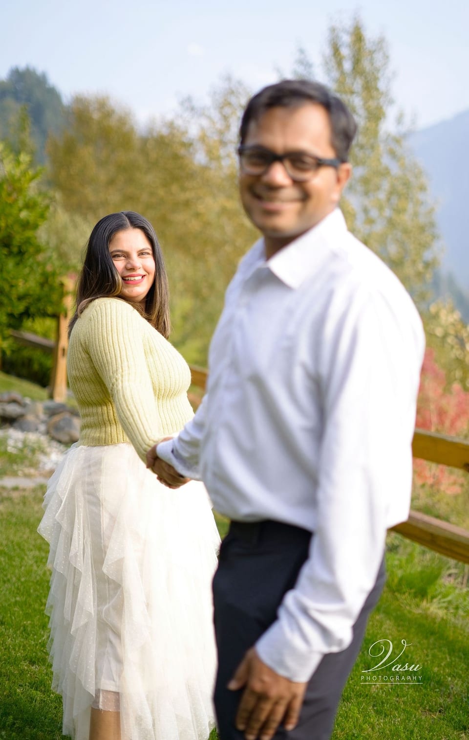 Couple holding hands during a playful outdoor portrait