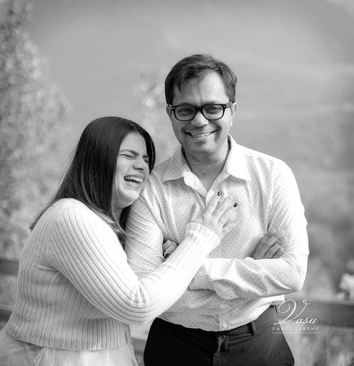 Couple sharing a laugh during a black-and-white portrait