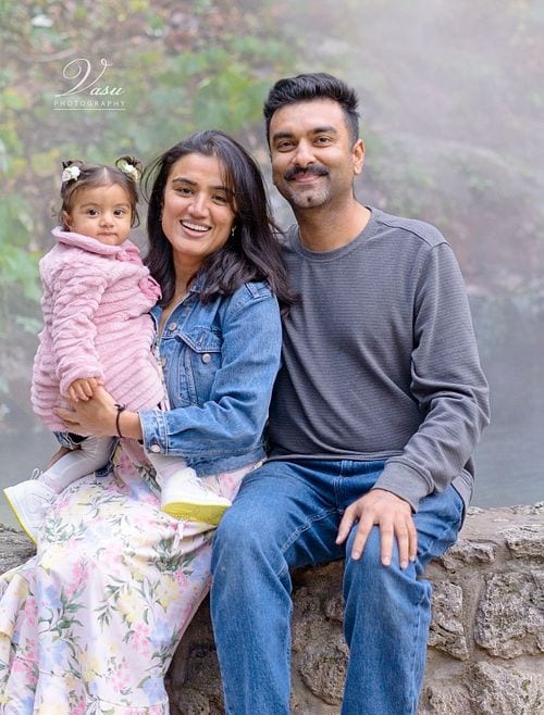 Family of three photographed together outdoors